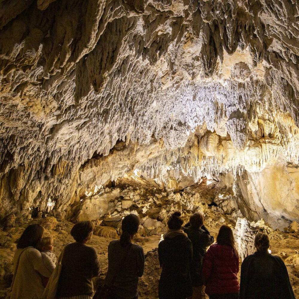 A group contemplates the formations in the caves of Urdazubi/Urdax